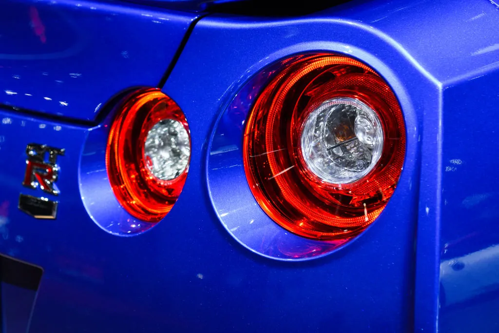 An image of the tail lights on a Nissan Skyline GT-R at a auto show.